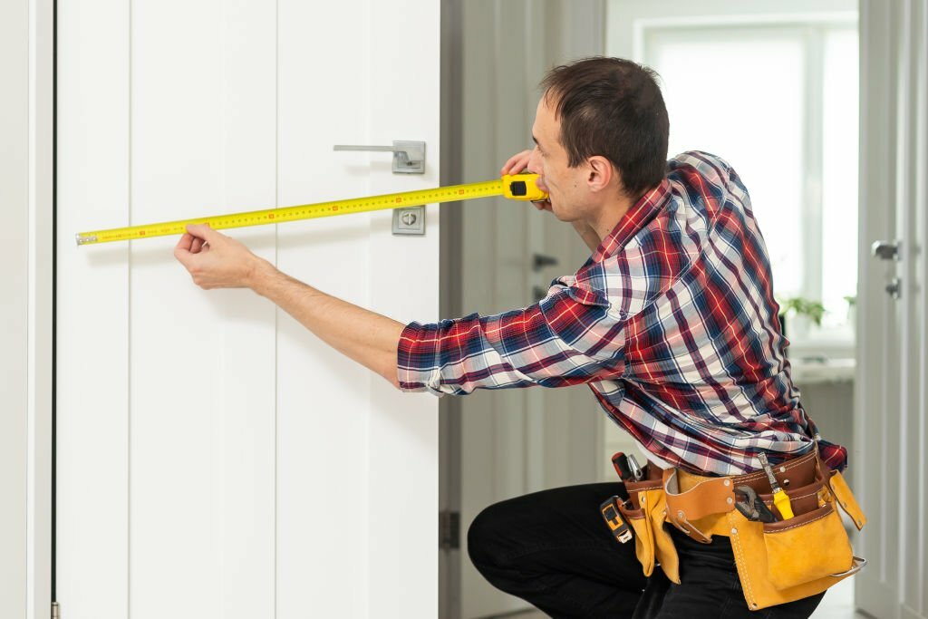 Locksmith, man and maintenance, handyman with home renovation and fixing, change door locks with power tools. Construction, building industry and trade with manual labour, vocation and employee. High quality photo