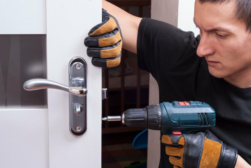 handyman repair the door lock in the room