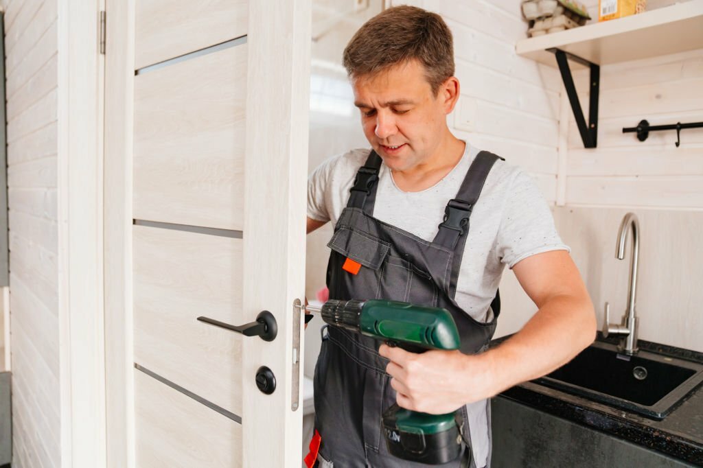 The master repairs or installs the door handle on the interior door. services of a repairman or installer of furniture and doors.